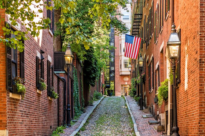 Visit Acorn Street, Boston's iconic cobblestone lane with gas lamps that date back to the 19th century